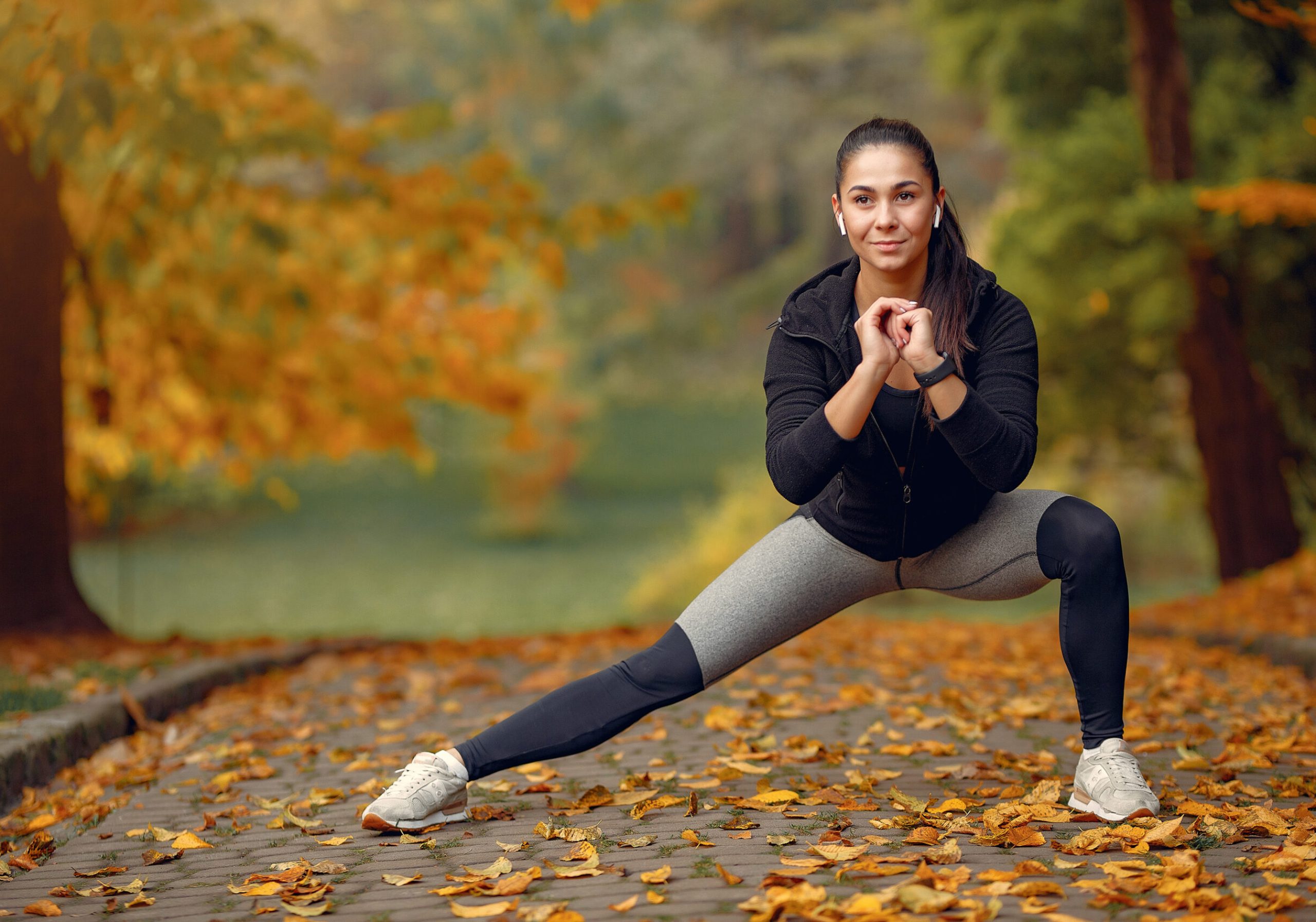 Beautiful girl training. Sports girl in a sportswear. Brunette in a black sweater